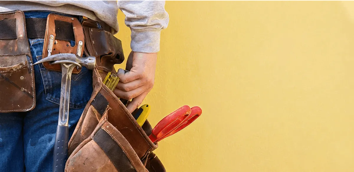 Handyman with tool belt ready for home repairs and maintenance in Shreveport, LA